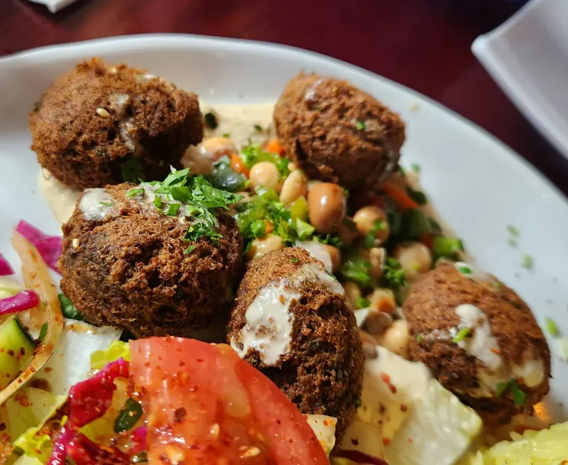 Falafel on salad with chickpeas and tahini
