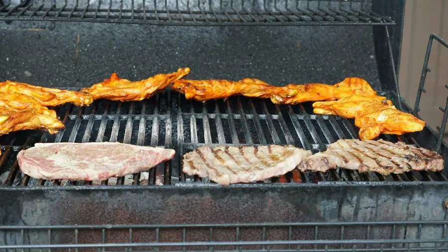 Chicken and steaks on a barbecue grill