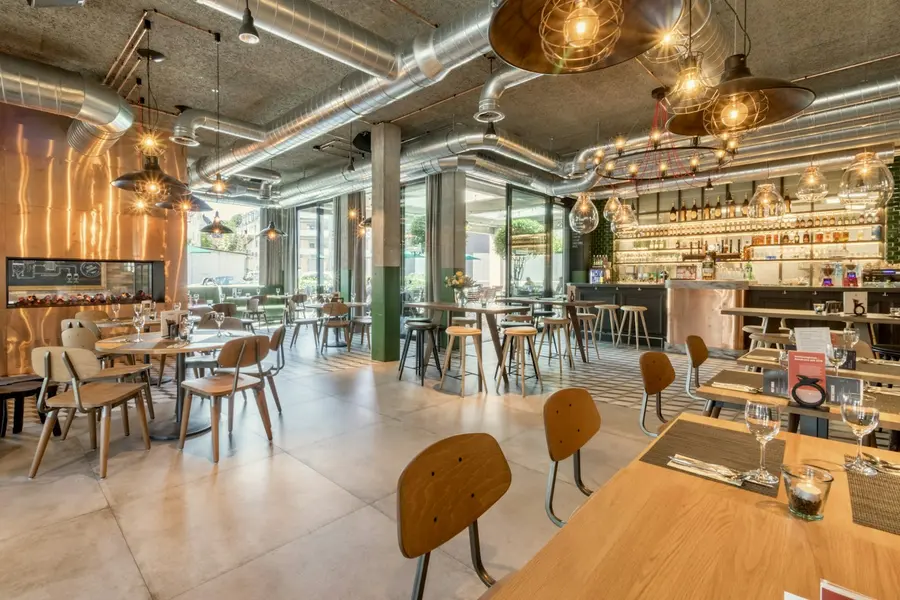 Warm restaurant dining room with wooden tables