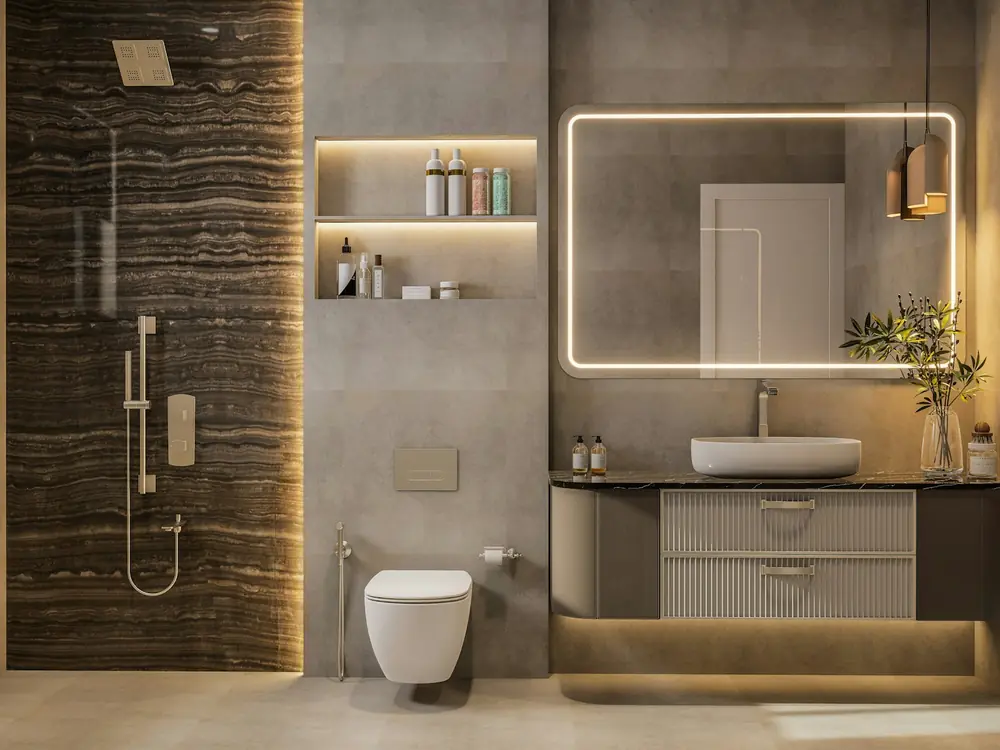 Finished bathroom with backlit mirror, wall-hung toilet and stone-look feature wall