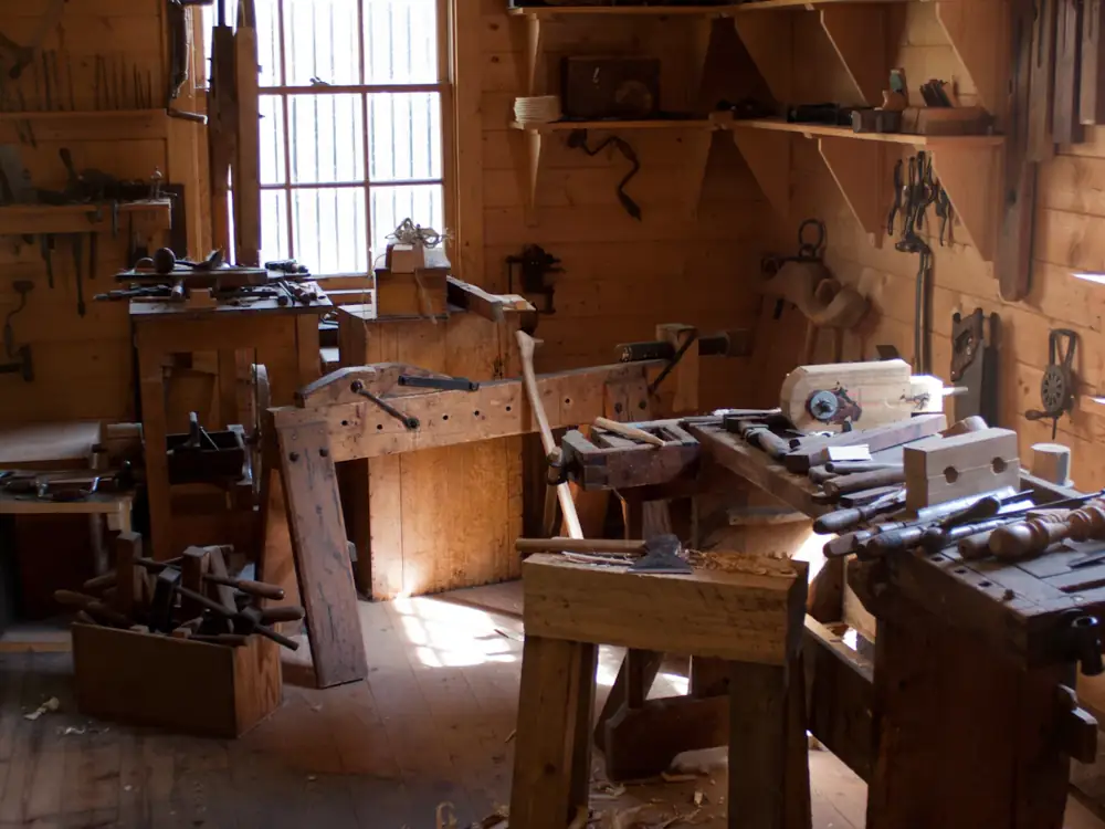 Timber workbenches, hand planes and tools in a joinery workshop