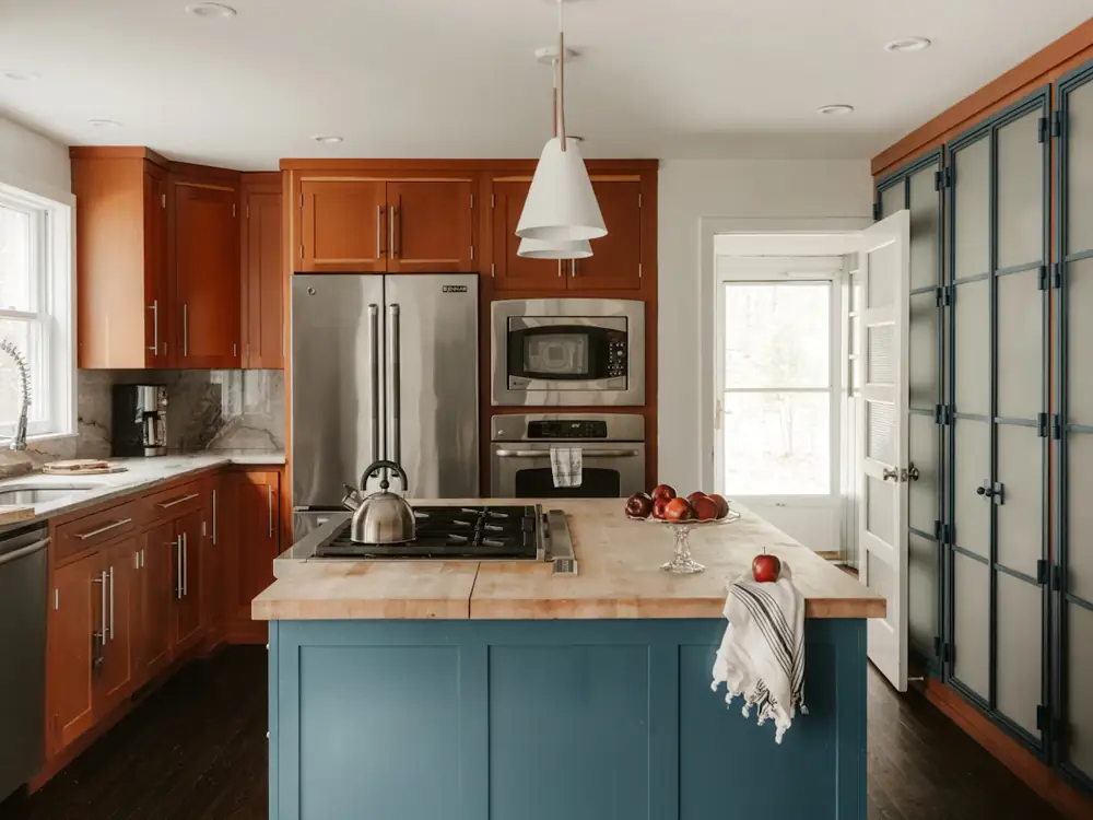 Kitchen with timber-look cabinets and a painted blue island bench
