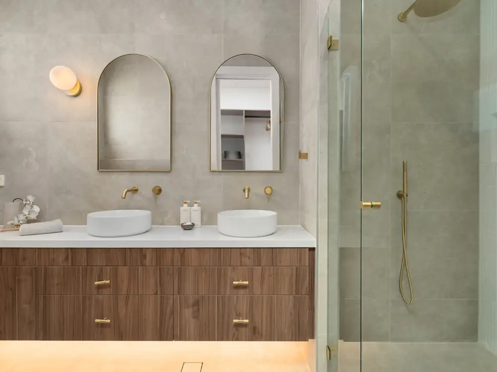 Floating timber vanity with two basins and brass tapware