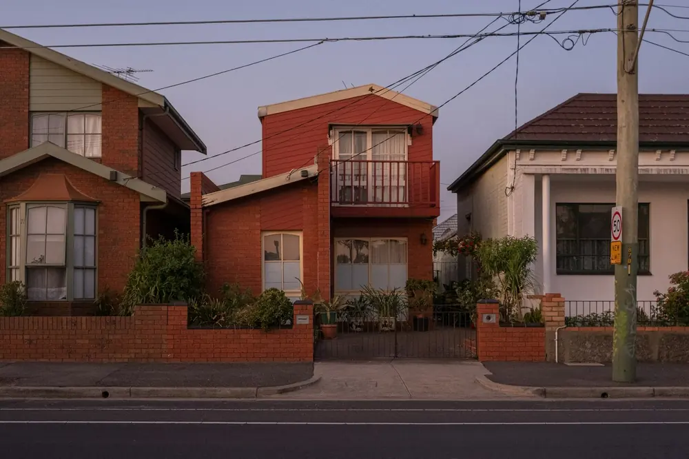 Row of brick houses on a suburban street at dusk