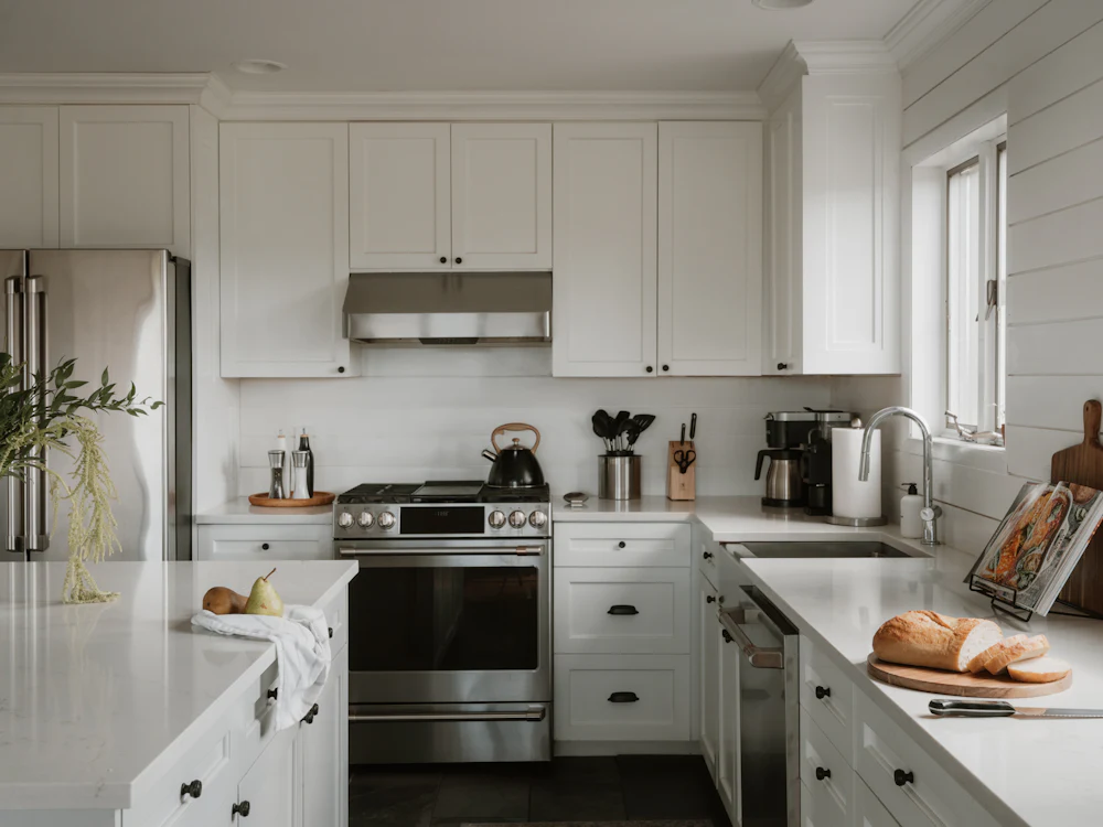 Clean white kitchen with gleaming benchtops