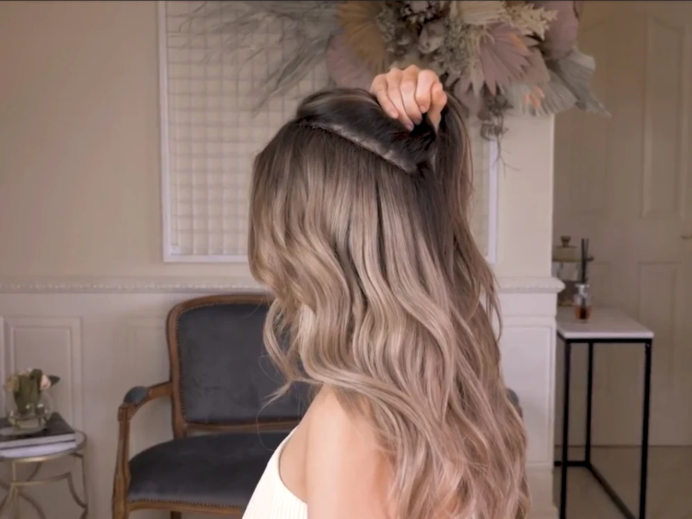 Long honey-blonde balayage with soft waves, seen from behind