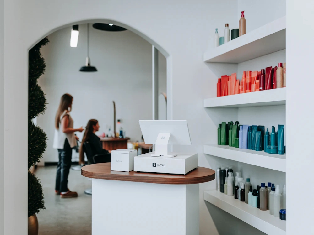 Bright studio with an arched doorway and product shelves