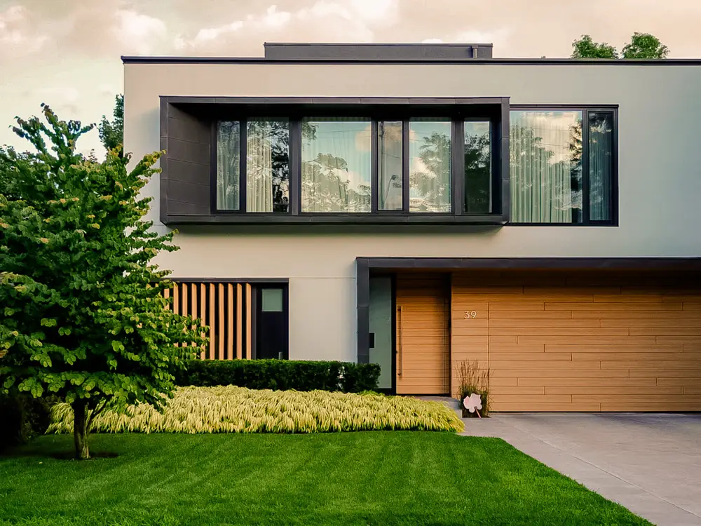 Modern two-storey home with a timber garage door and front lawn