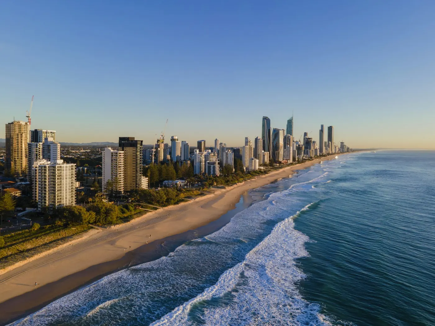Gold Coast beachfront and high-rise skyline from the air at sunrise
