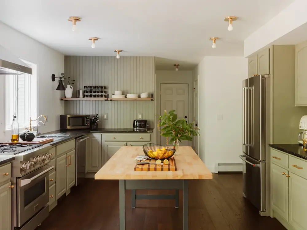 Kitchen with sage cabinets and a timber-top island