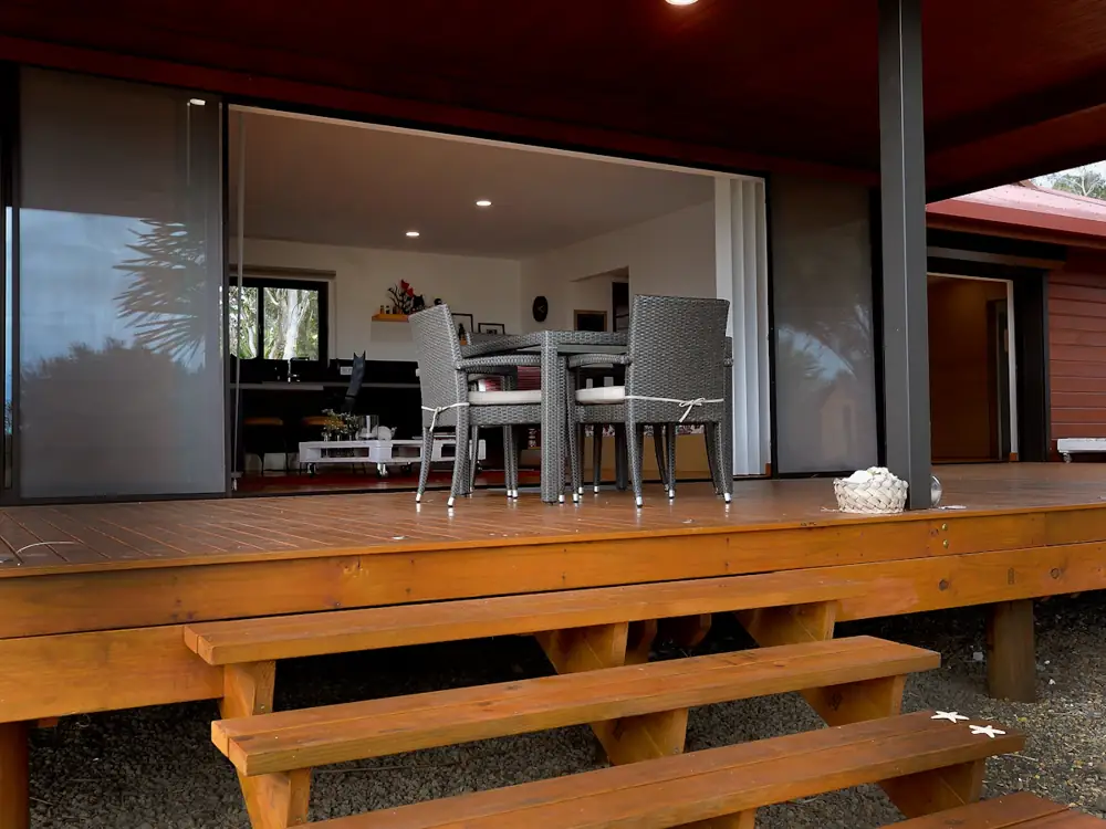 Timber alfresco deck with steps, opening onto a living room