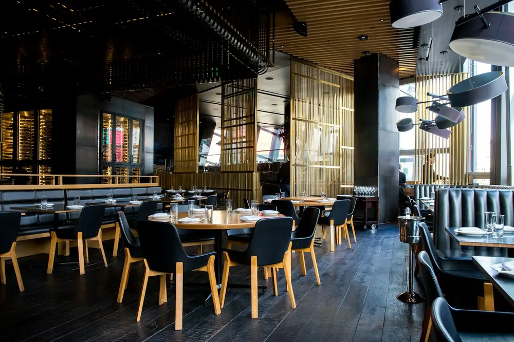 Dining room with timber tables and dark chairs