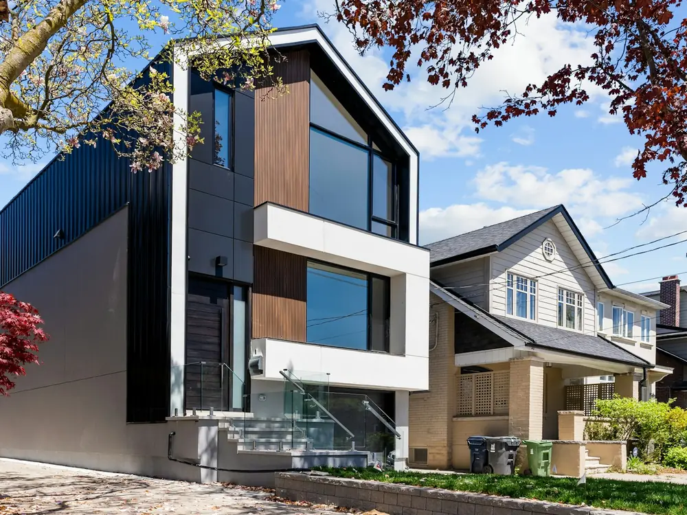After: a redesigned home with dark cladding, timber battens and large glazing