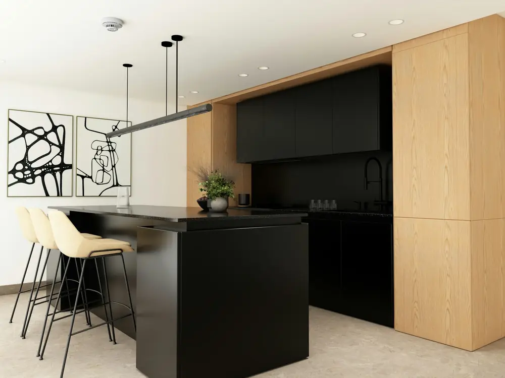 Kitchen with black island, pale timber tall cabinets and pendant lights