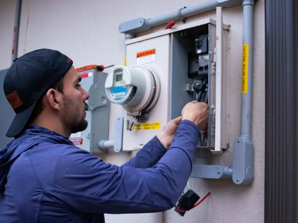 Electrician checking a home's meter box and main switch