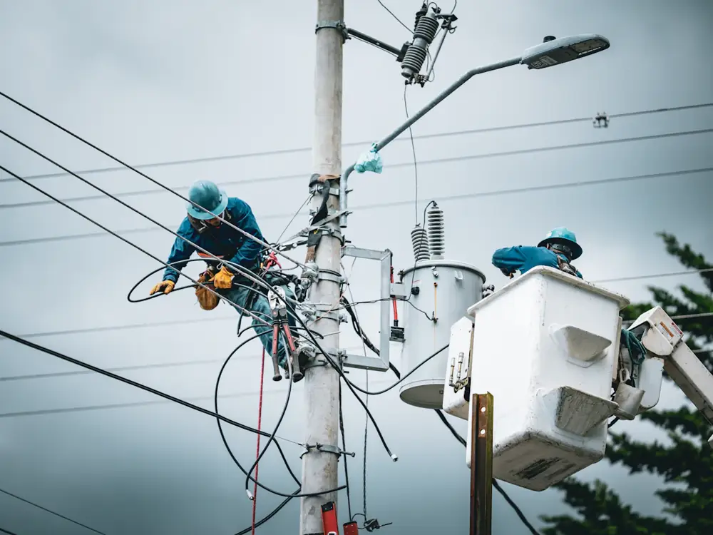 Network crews repairing overhead powerlines after a storm