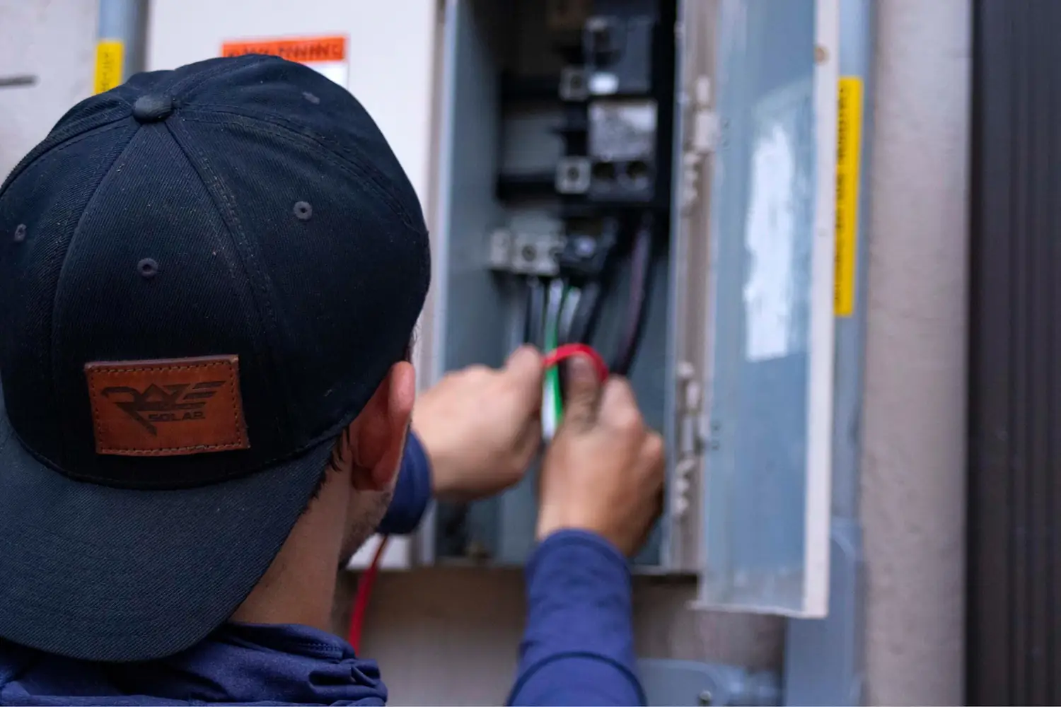 Northgate electrician testing wiring inside an open switchboard