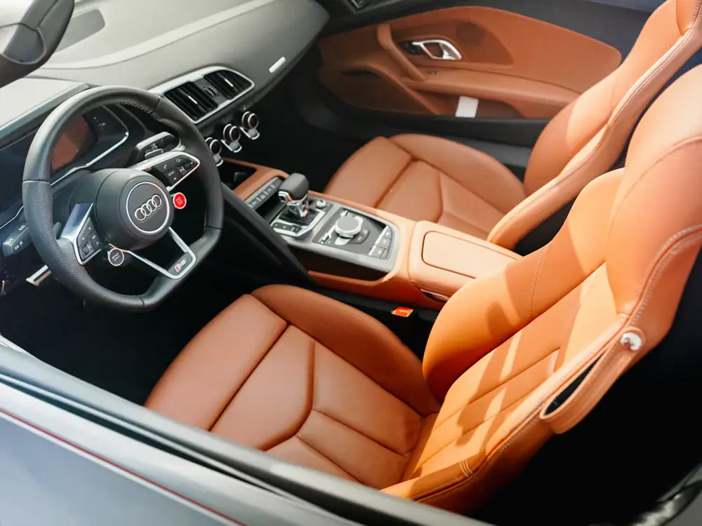 Tan leather sports seats and dashboard, cleaned and conditioned