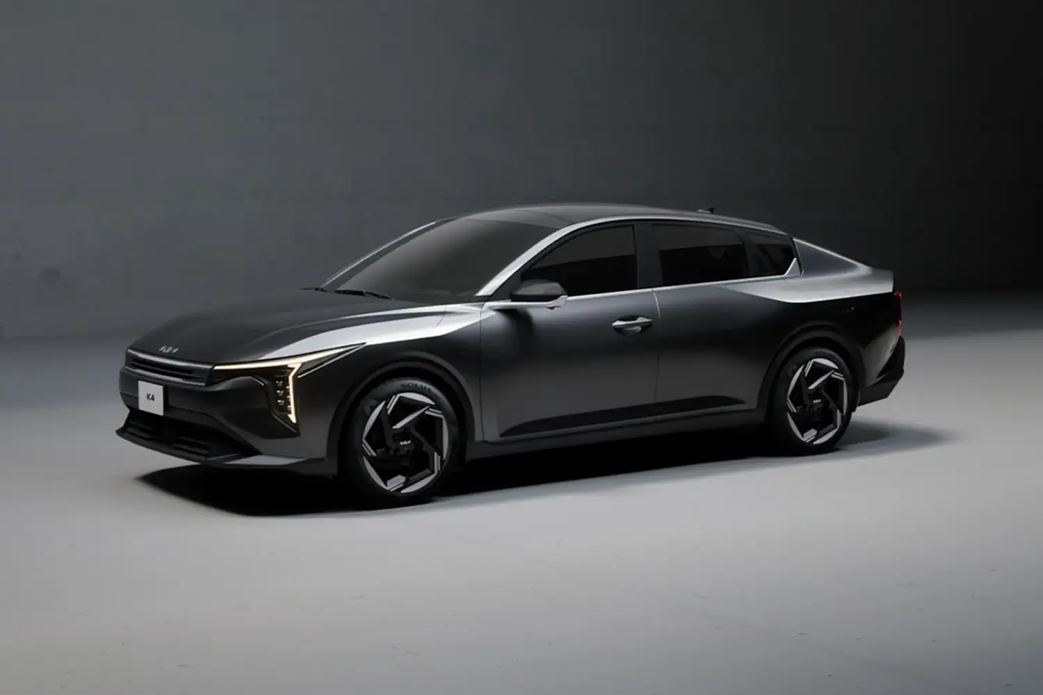 Gunmetal sedan under soft studio lights, paint showing deep reflections