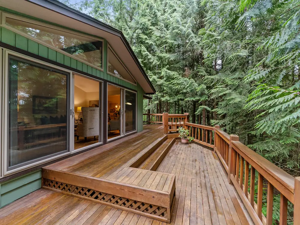 Hardwood deck with bench seat alongside a home