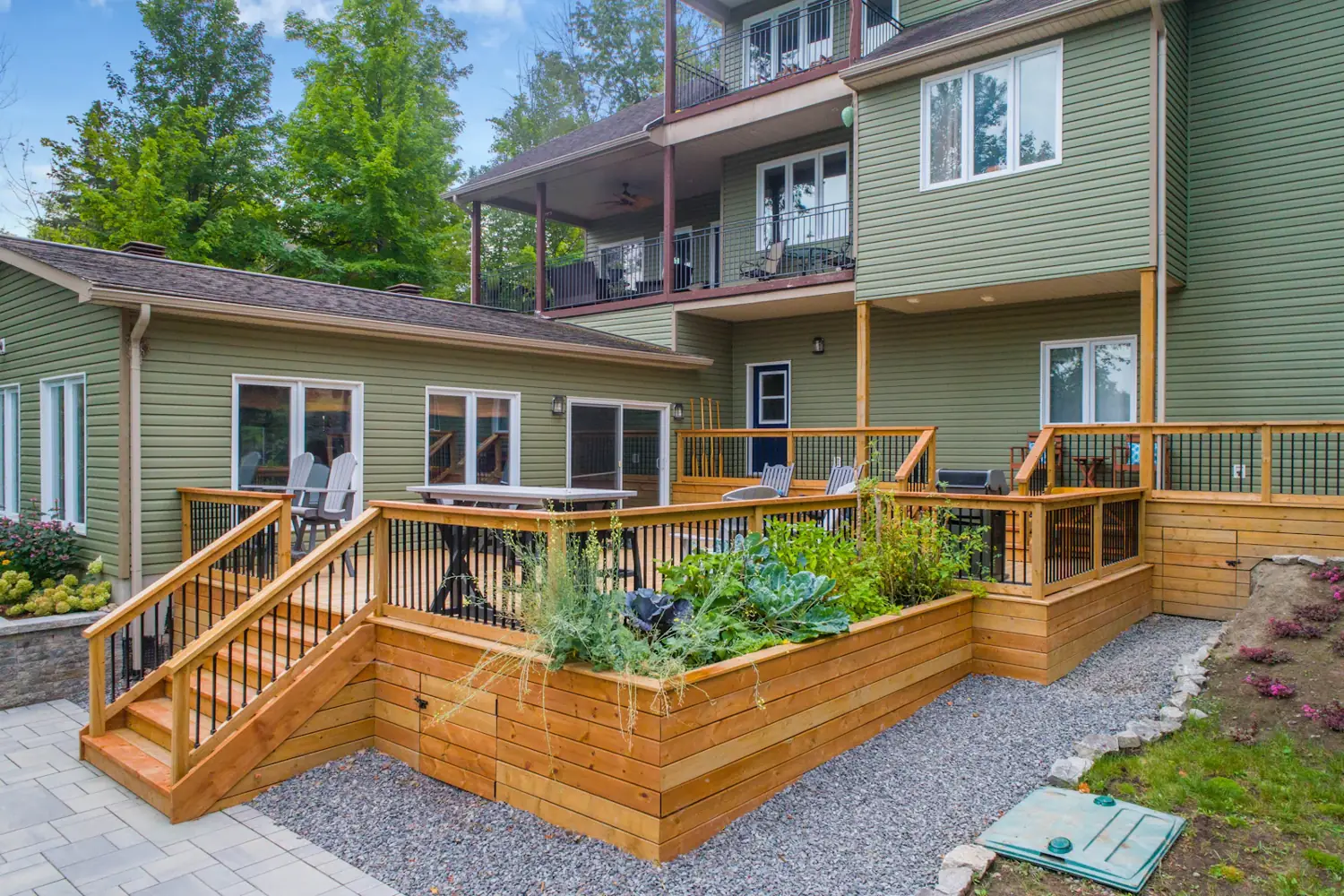 Two-level timber deck with stairs, black balustrade and built-in planter boxes