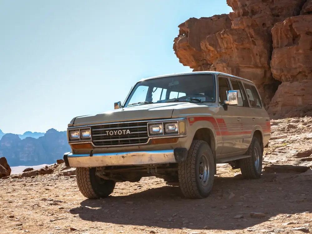 Classic LandCruiser wagon parked on red rock
