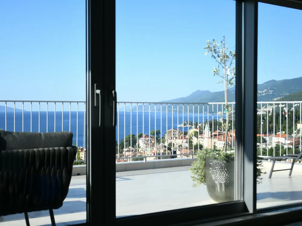Tiled balcony with glass balustrade overlooking the ocean