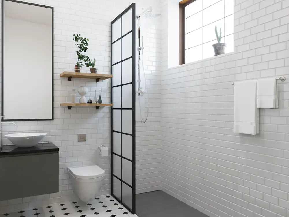 White subway-tiled bathroom with a black-framed shower screen and floating vanity