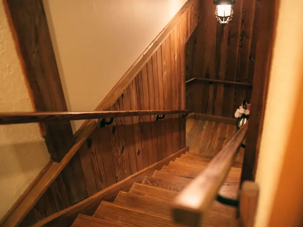 Timber staircase with a wall-mounted timber handrail